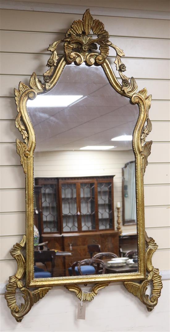 A large gilt-framed wall mirror, with shaped rectangular plate H.134cm